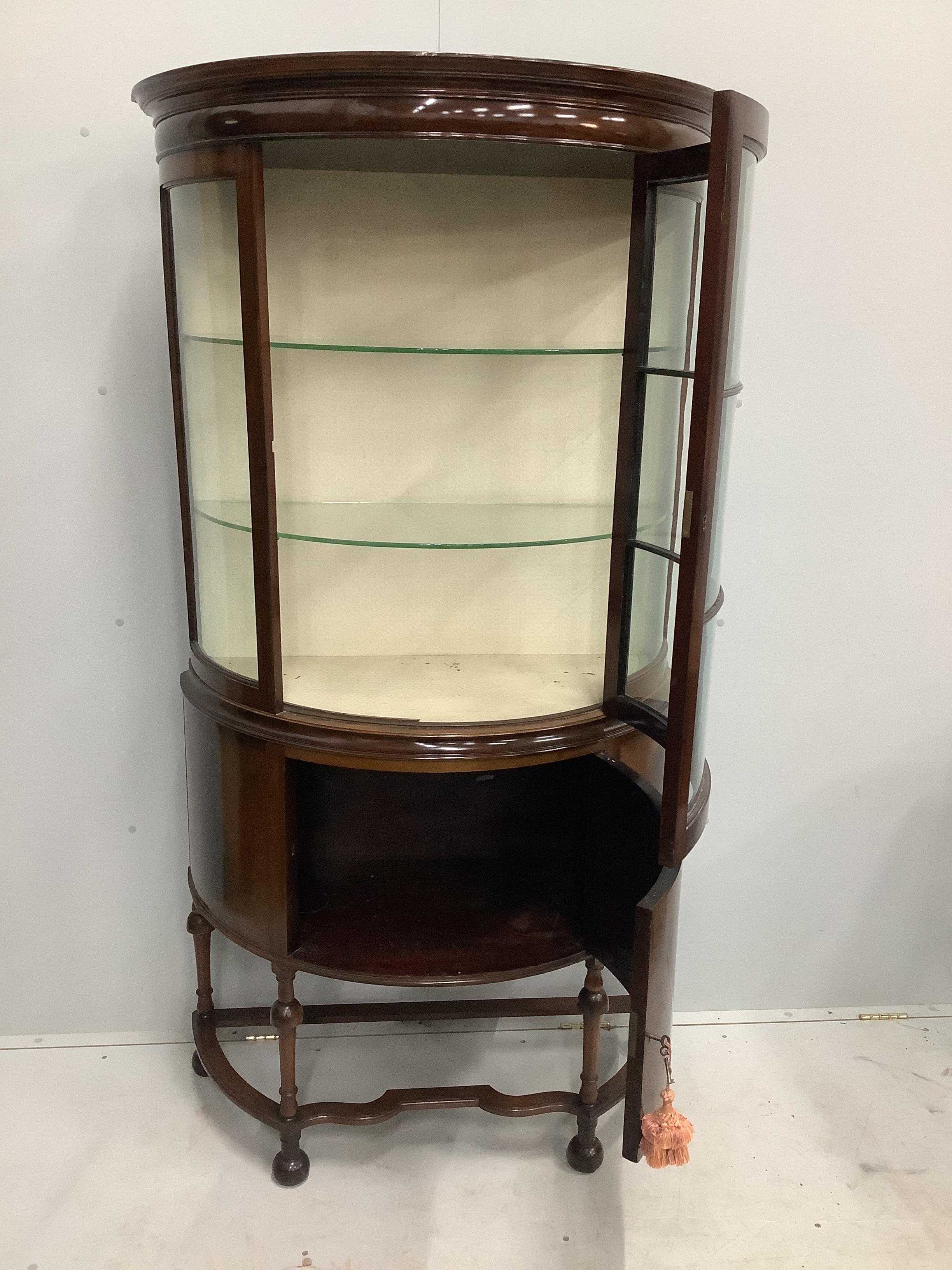 An Edwardian mahogany bow fronted glazed china display cabinet, with cupboard under, width 97cm, depth 44cm, height 181cm